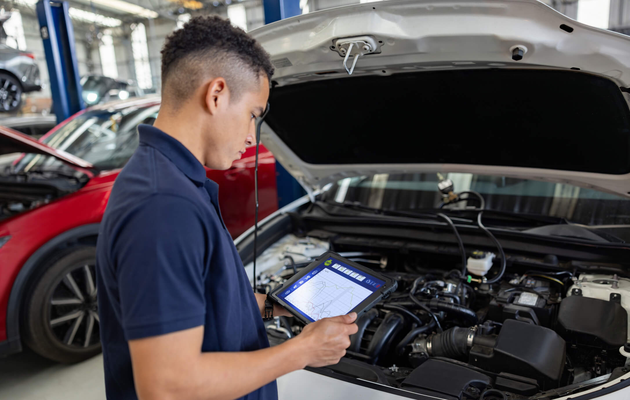 Mechanic using tablet for car diagnostics