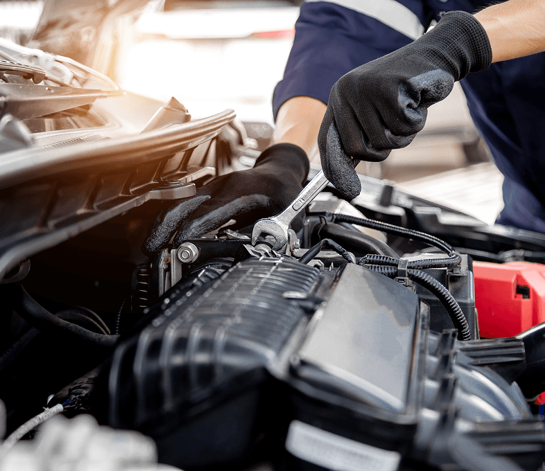 Mechanic working under car hood