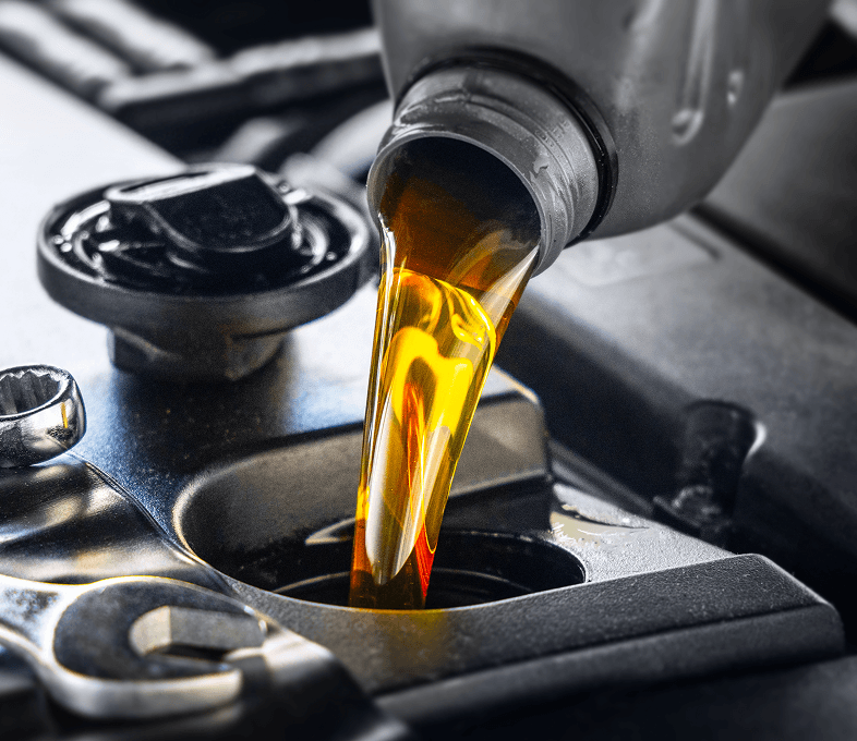 Pouring engine oil into car engine