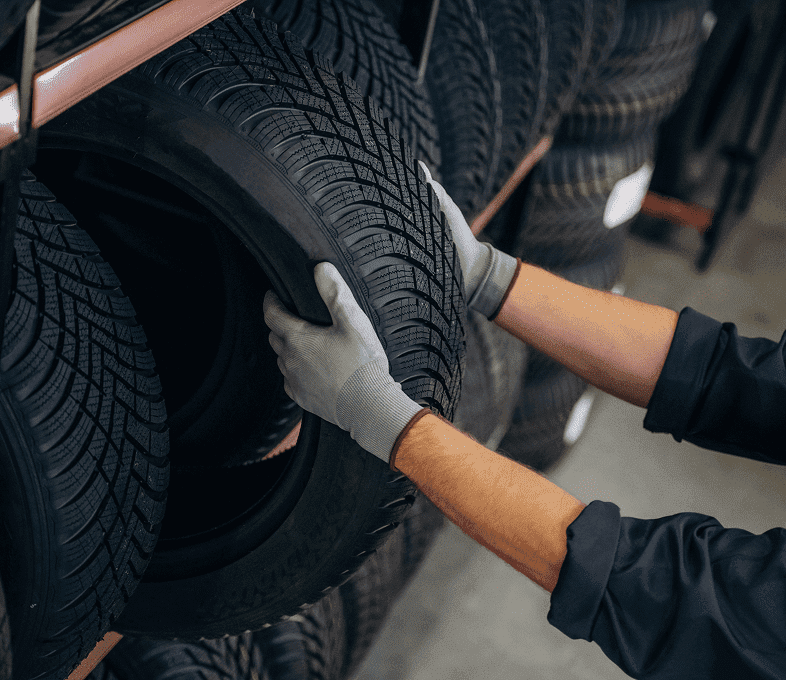 Mechanic handling a car tire